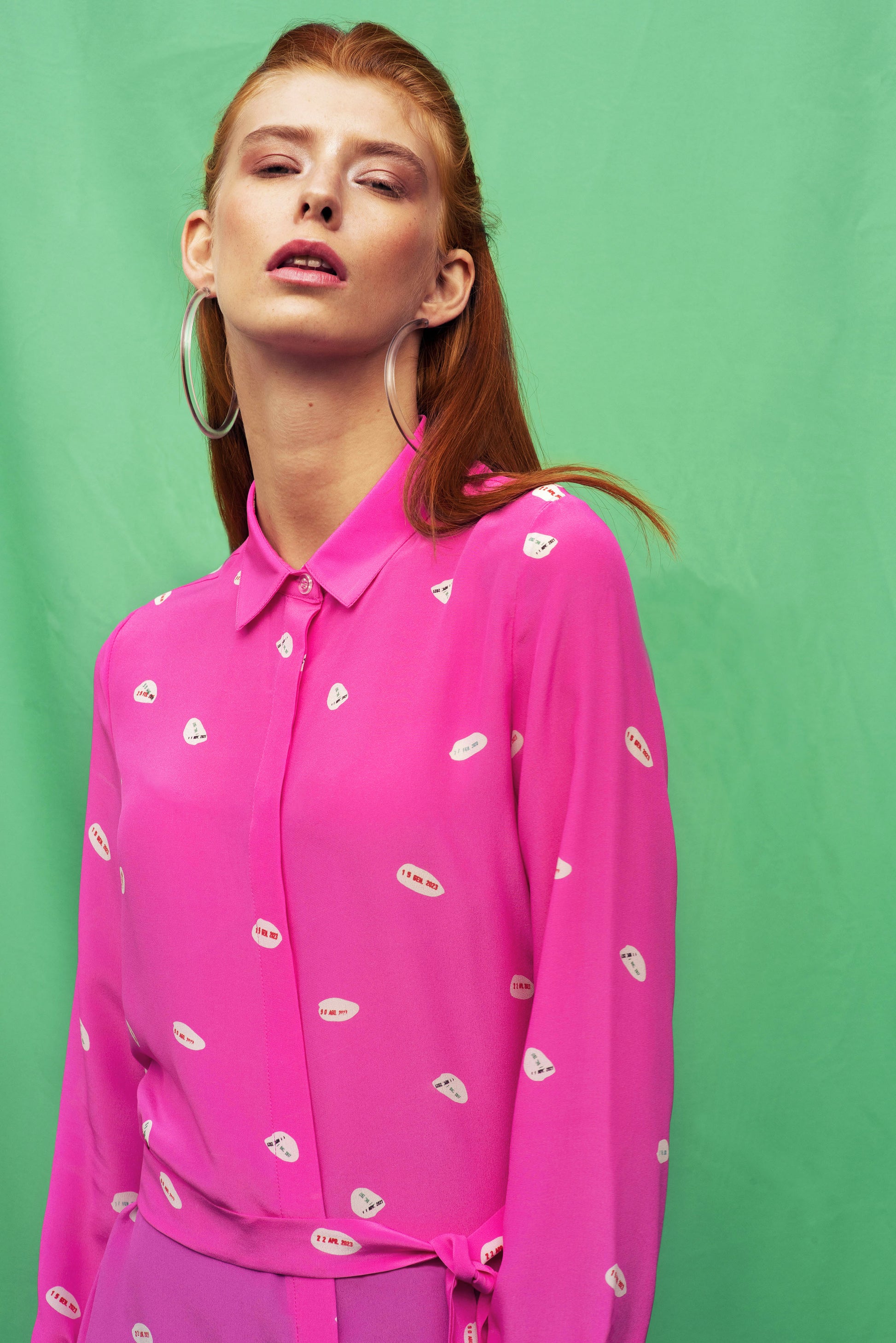 Luana Ga' silk shirt in shocking pink colour .The bow can be used also as belt.